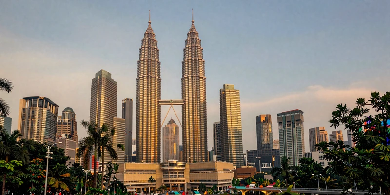Kuala Lumpur skyline with Petronas Towers at golden hour sunset