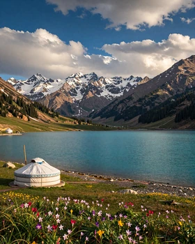 Stunning alpine lake in Kyrgyzstan with traditional yurt and Tien Shan mountains